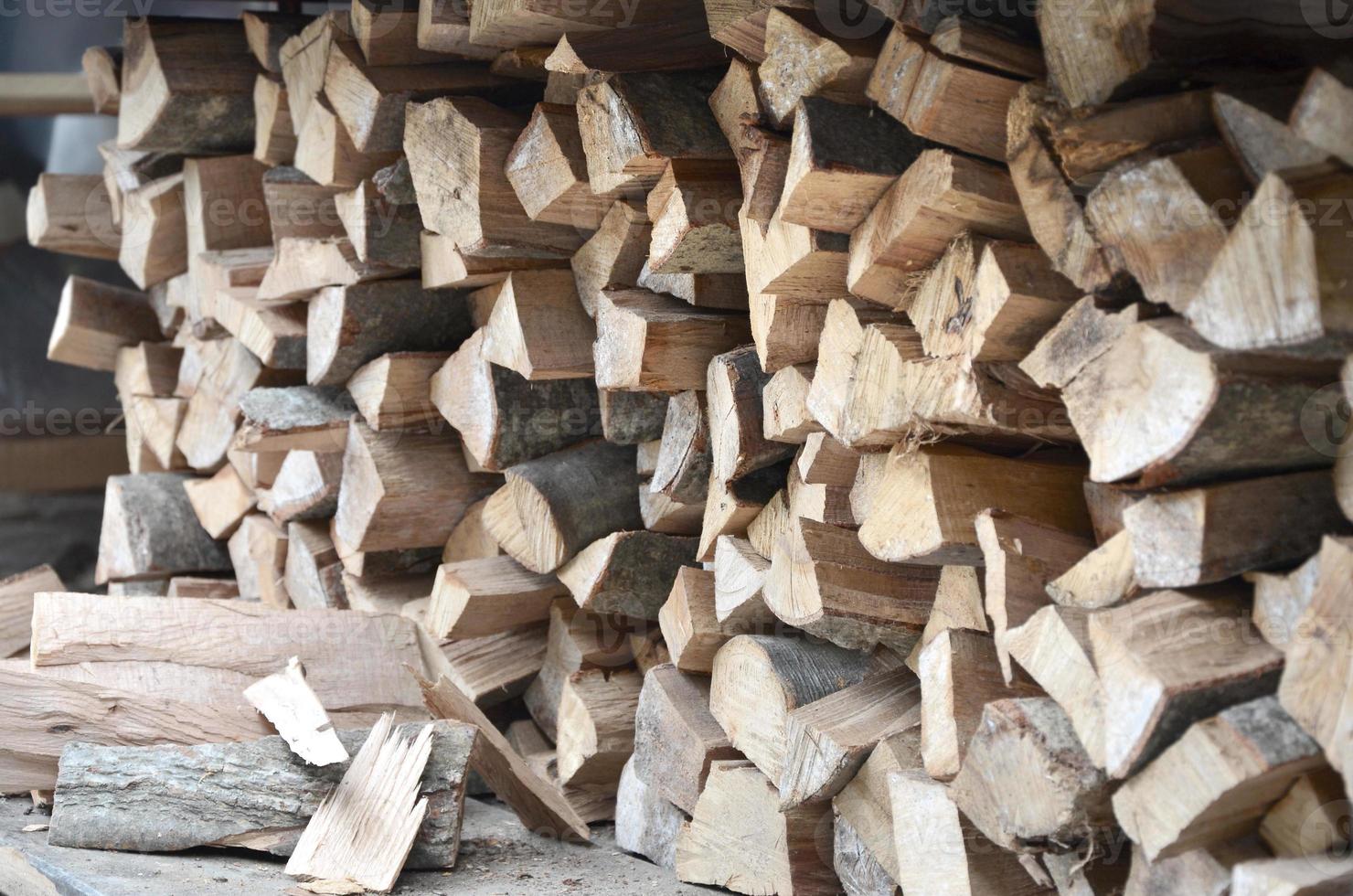 A lot of dry chopped firewood is stacked in the period of preparation for the furnace photo