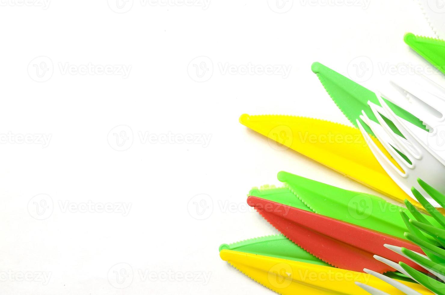 Pile of bright yellow, green and white plastic kitchenware single use appliances photo