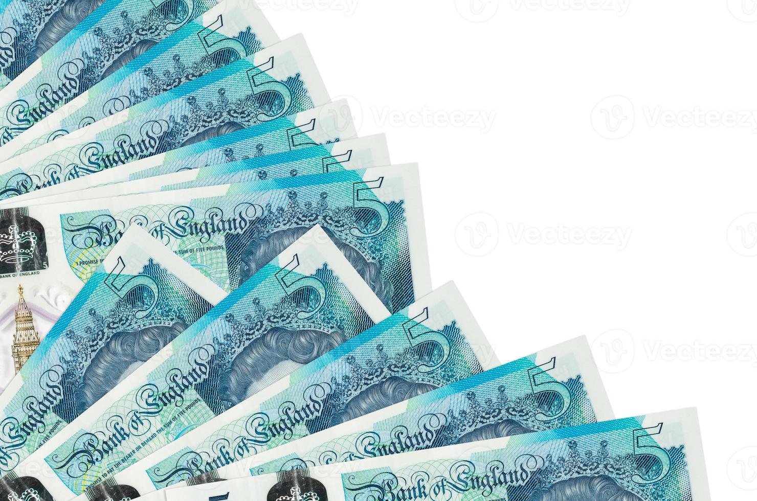 5 British pounds bills lies isolated on white background with copy space stacked in fan close up photo