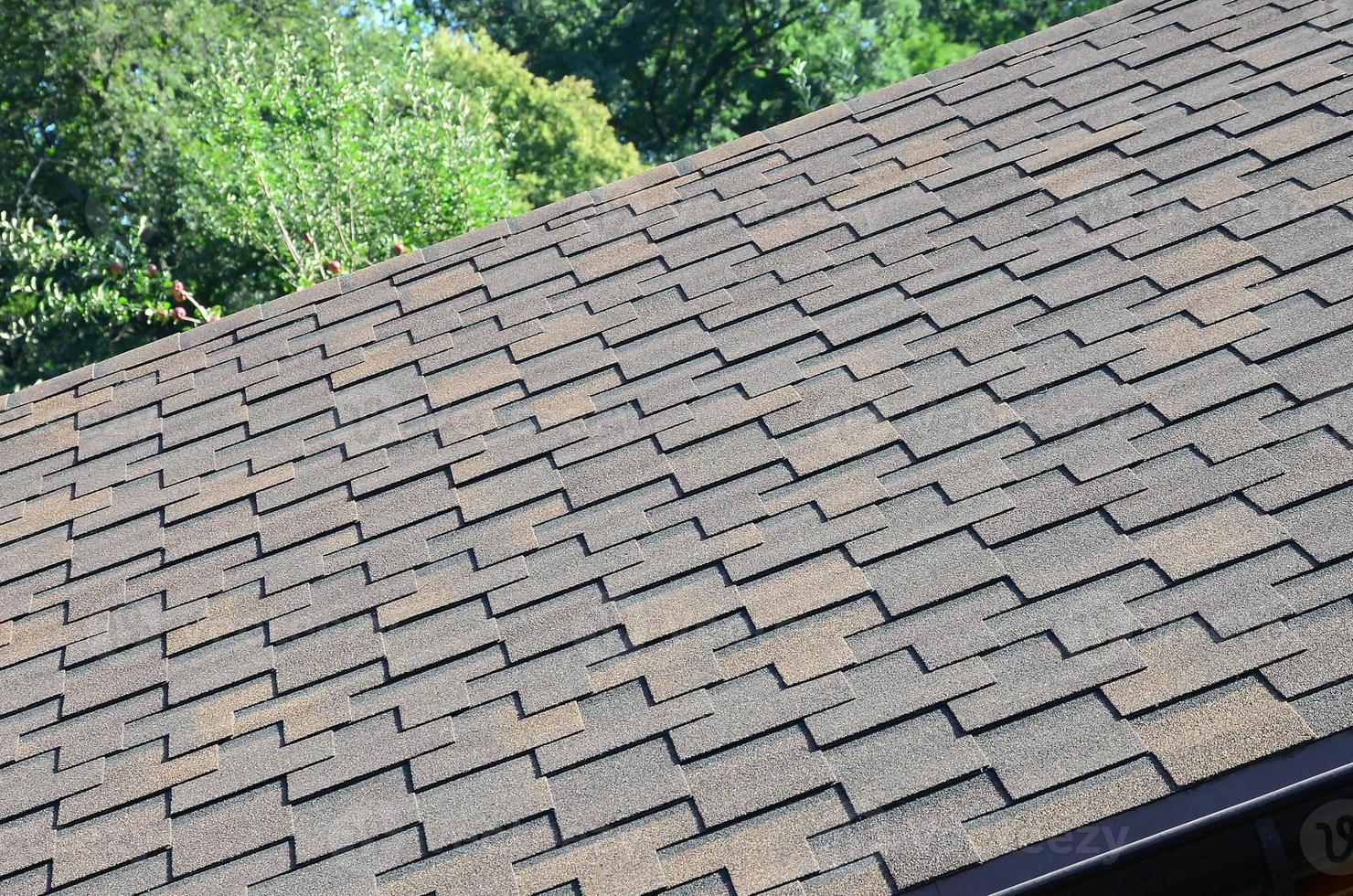 Modern roofing and decoration of chimneys. Flexible bitumen or slate shingles photo