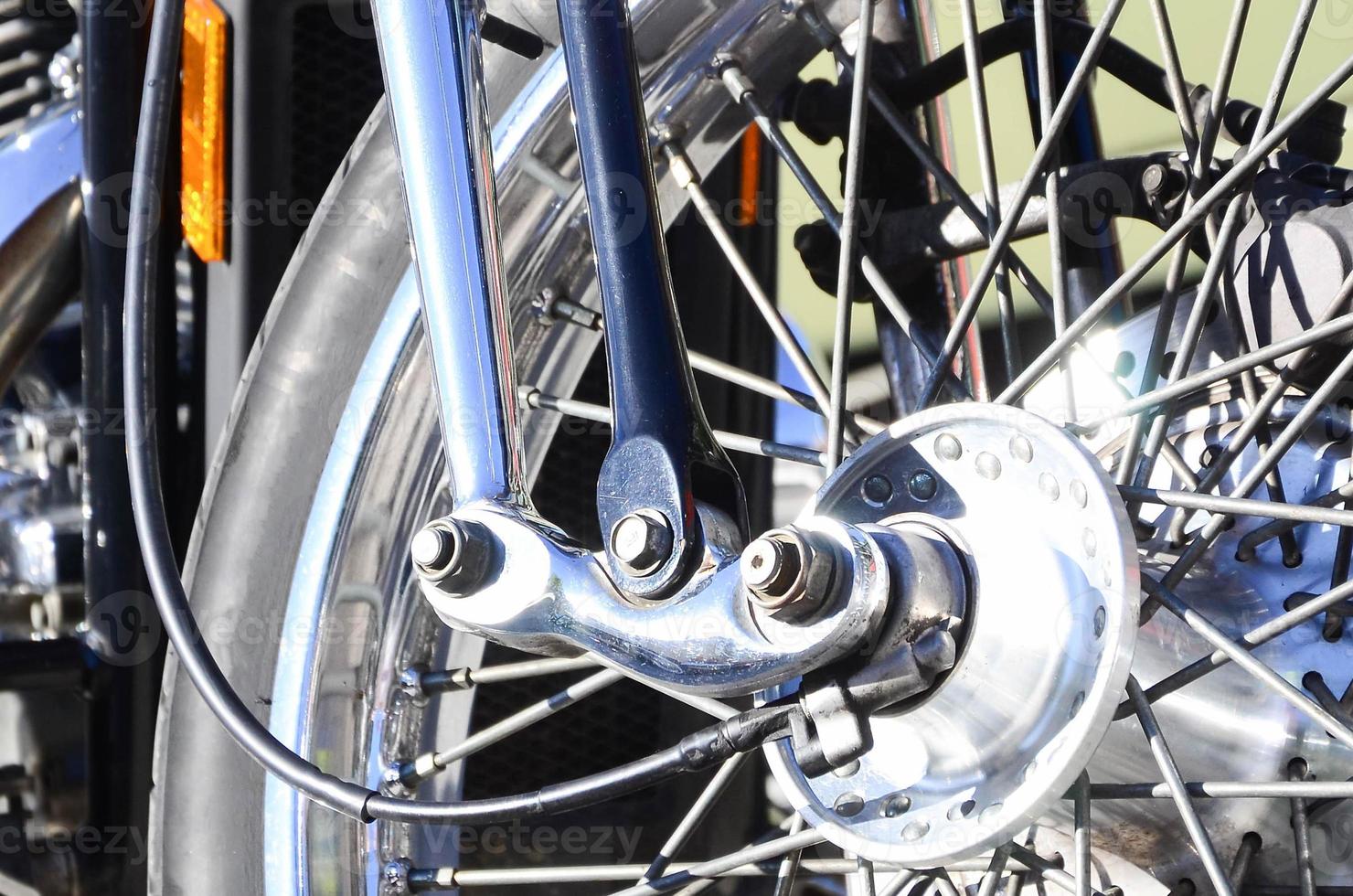 Fragment of chromed shiny wheel of old classic motorbike photo