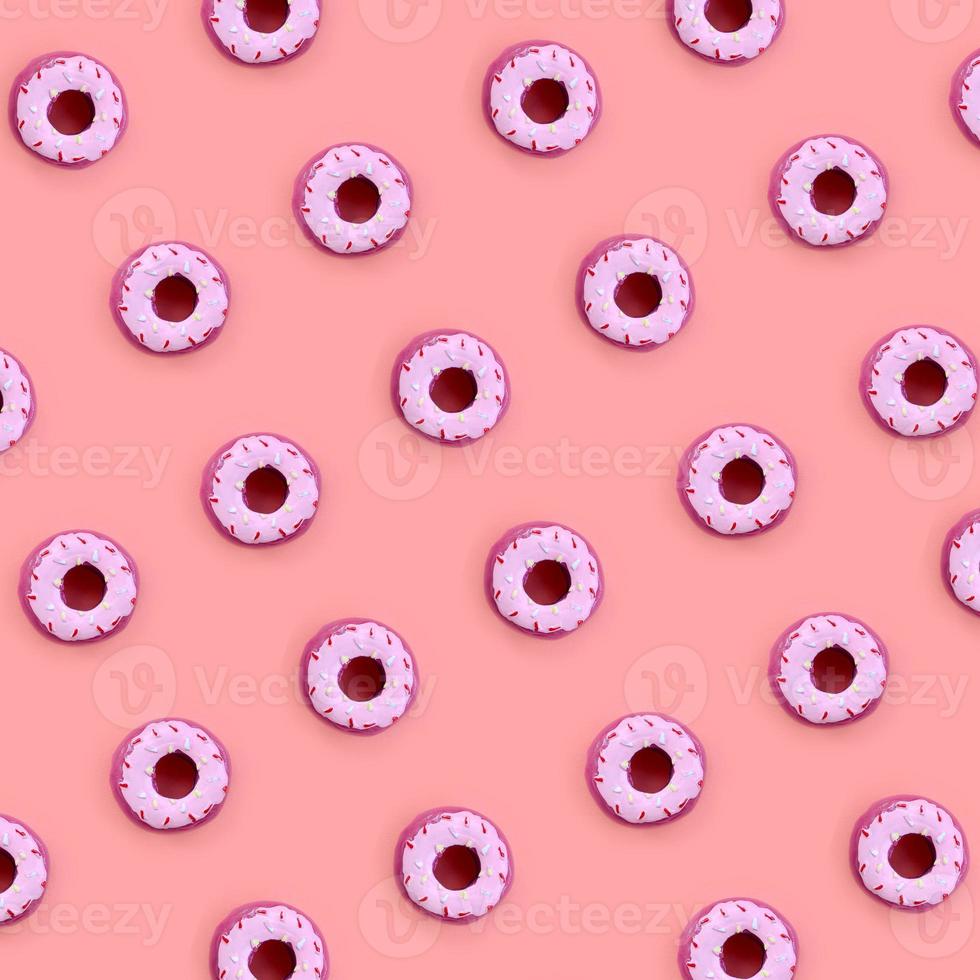 Many small plastic donuts lies on a pastel colorful background. Flat lay minimal pattern. Top view photo