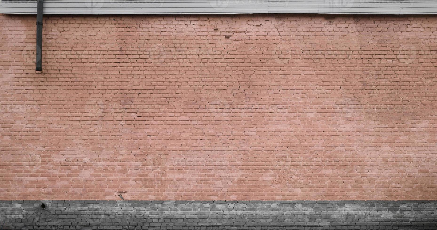 The texture of the brick wall of many rows of bricks painted in brown color photo