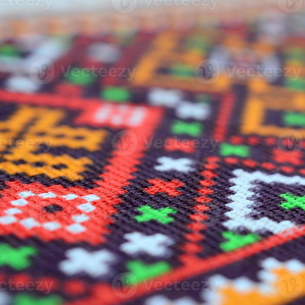 Traditional Ukrainian folk art knitted embroidery pattern on textile fabric photo