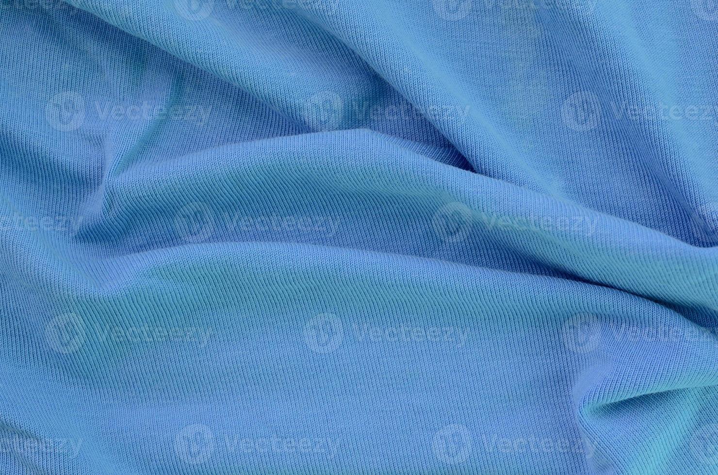The texture of the fabric in blue color. Material for making shirts and blouses photo