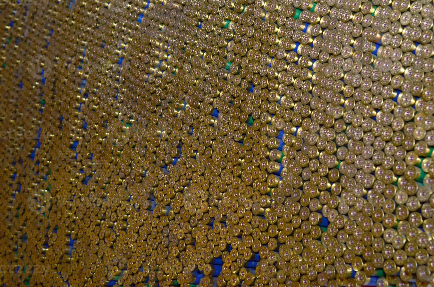 Pattern of 12 gauge cartridges for shotgun bullets. Shells for hunting rifle close up. Backdrop for shooting range or ammunition trade concepts photo