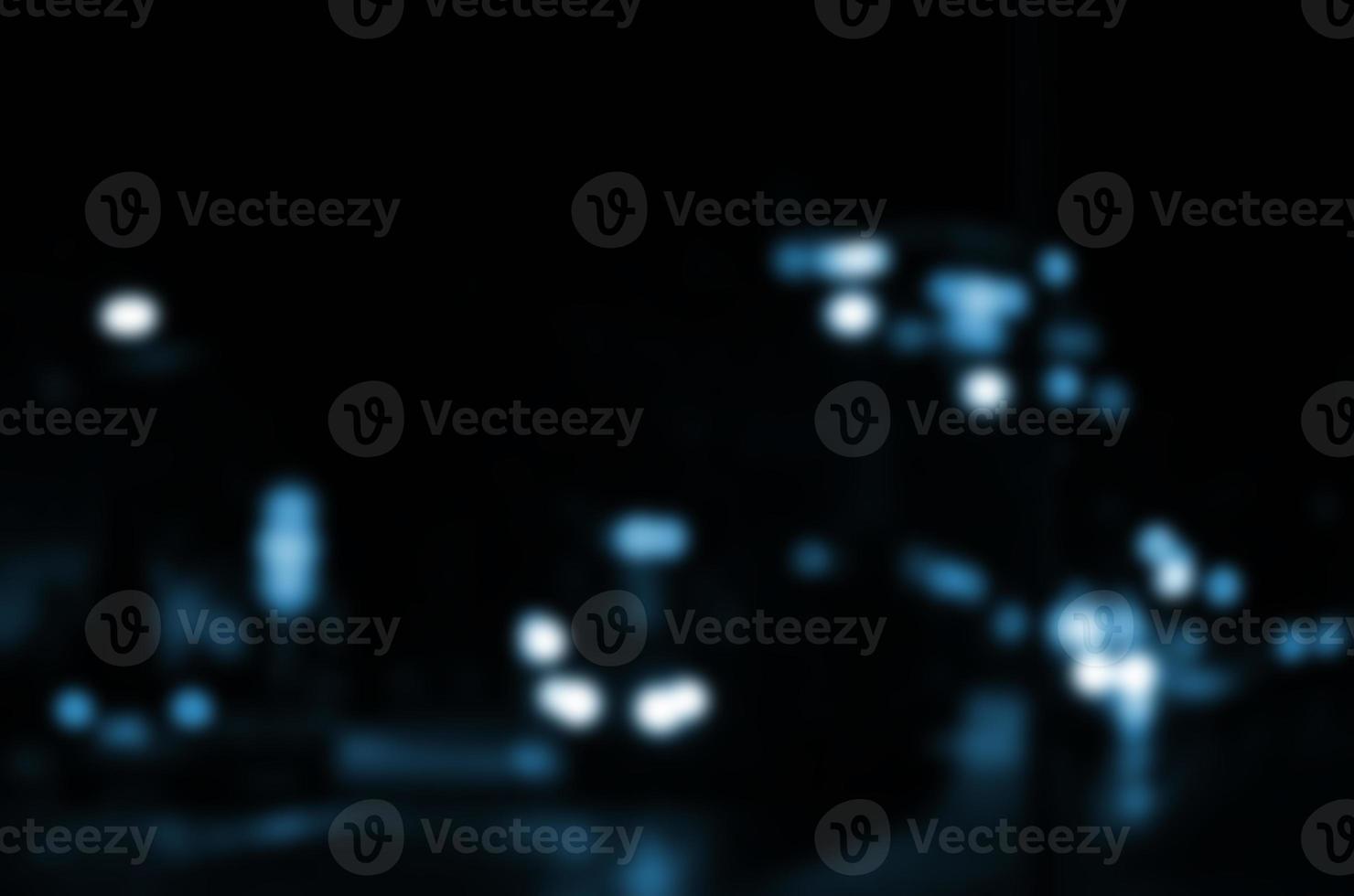 Blurred night scene of traffic on the roadway. Defocused image of cars traveling with luminous headlights. Bokeh Art photo