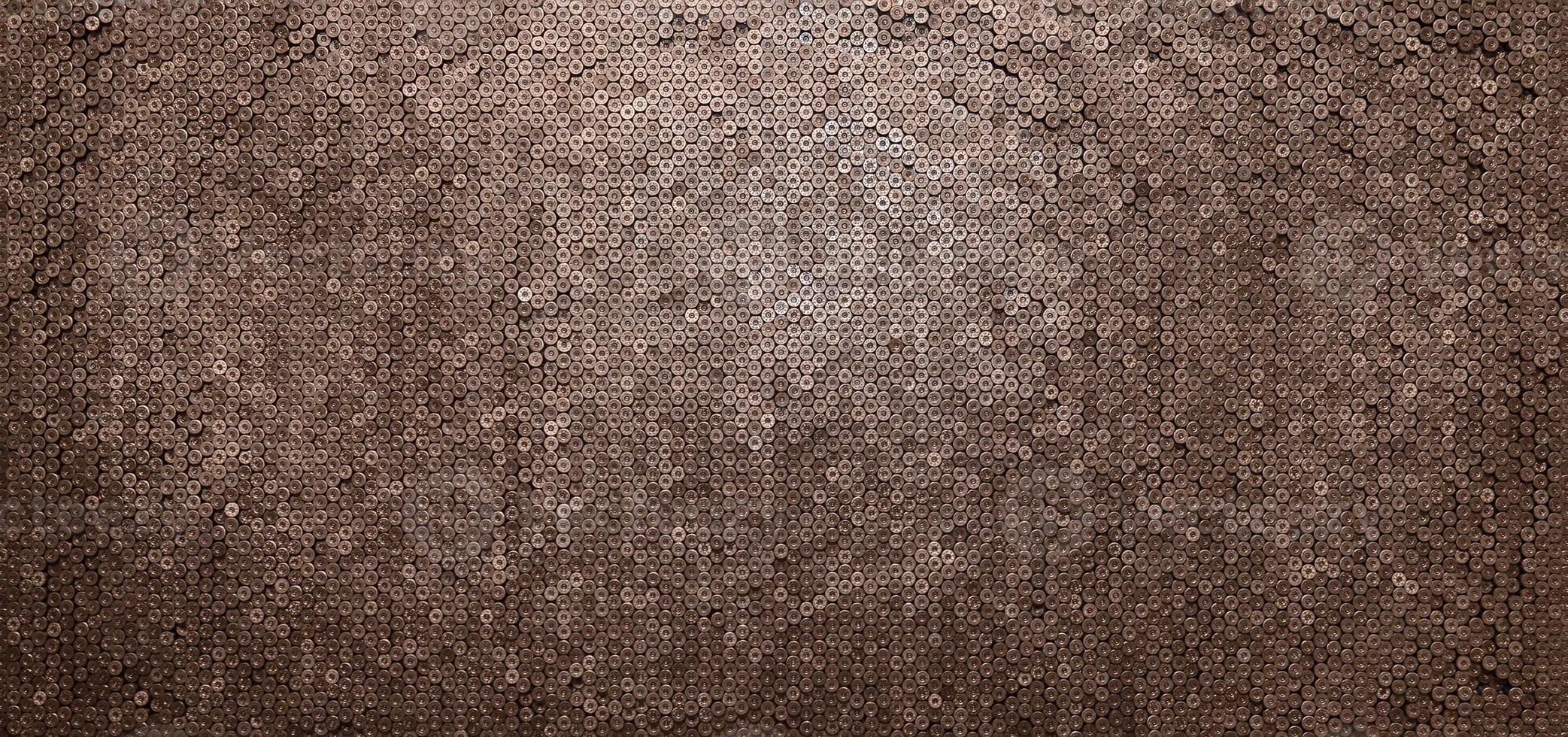 Pattern of 12 gauge cartridges for shotgun bullets. Shells for hunting rifle close up. Backdrop for shooting range or ammunition trade concepts photo