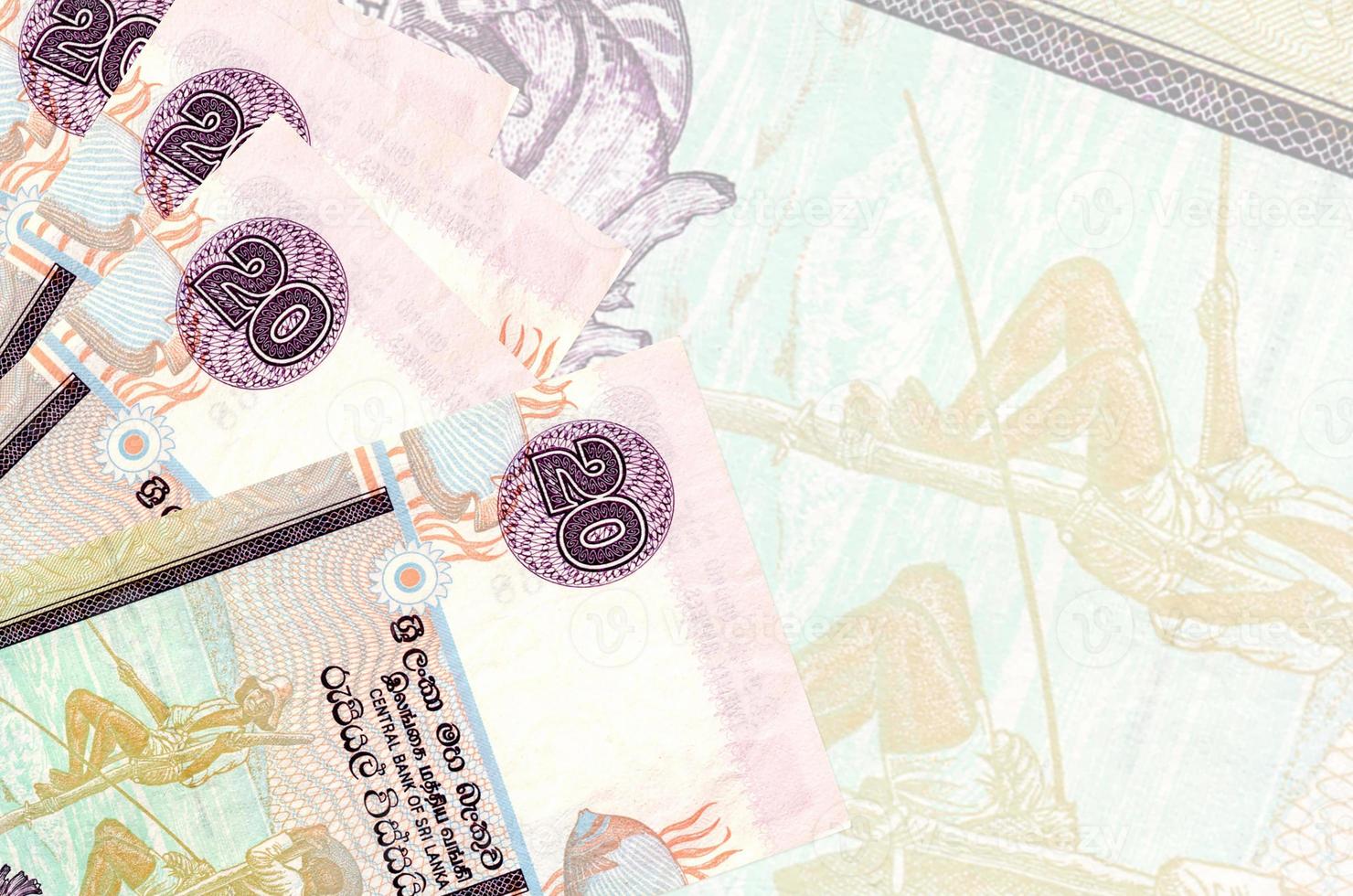 20 Sri Lankan rupees bills lies in stack on background of big semi-transparent banknote. Abstract business background photo