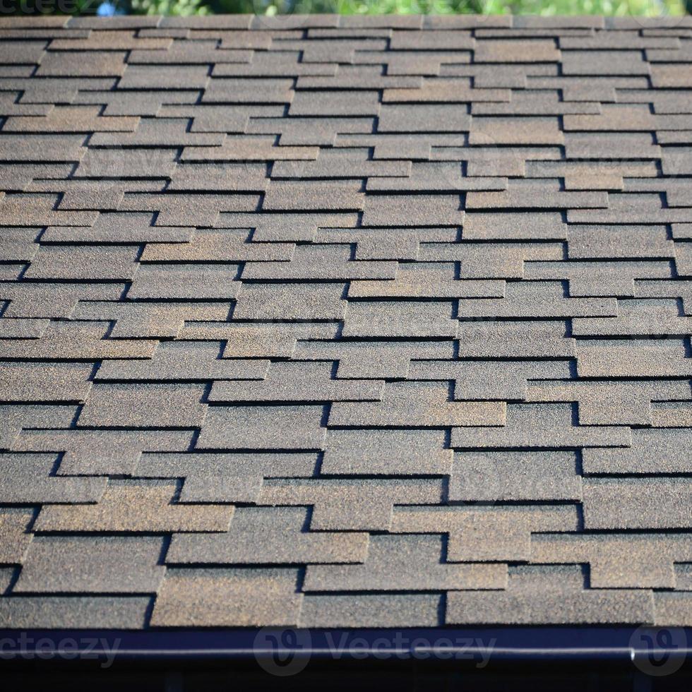 Modern roofing and decoration of chimneys. Flexible bitumen or slate shingles photo