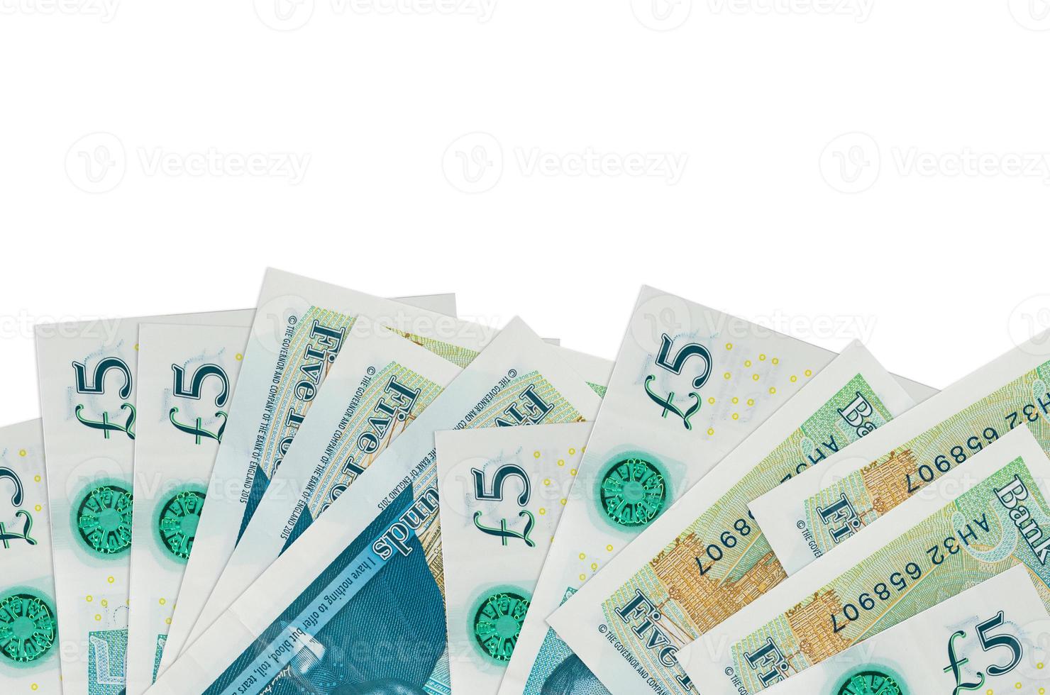 5 British pounds bills lies on bottom side of screen isolated on white background with copy space. Background banner template photo