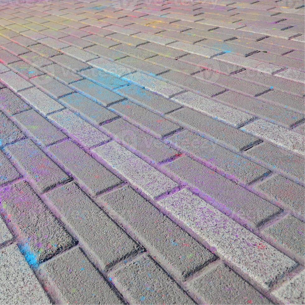 Multi colored paving slabs, powder coated with dry colors at the Holi festival photo