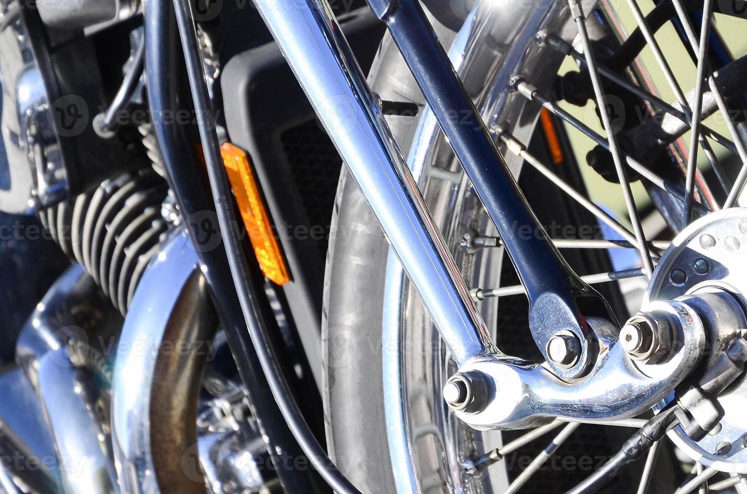 Fragment of chromed shiny wheel of old classic motorbike photo