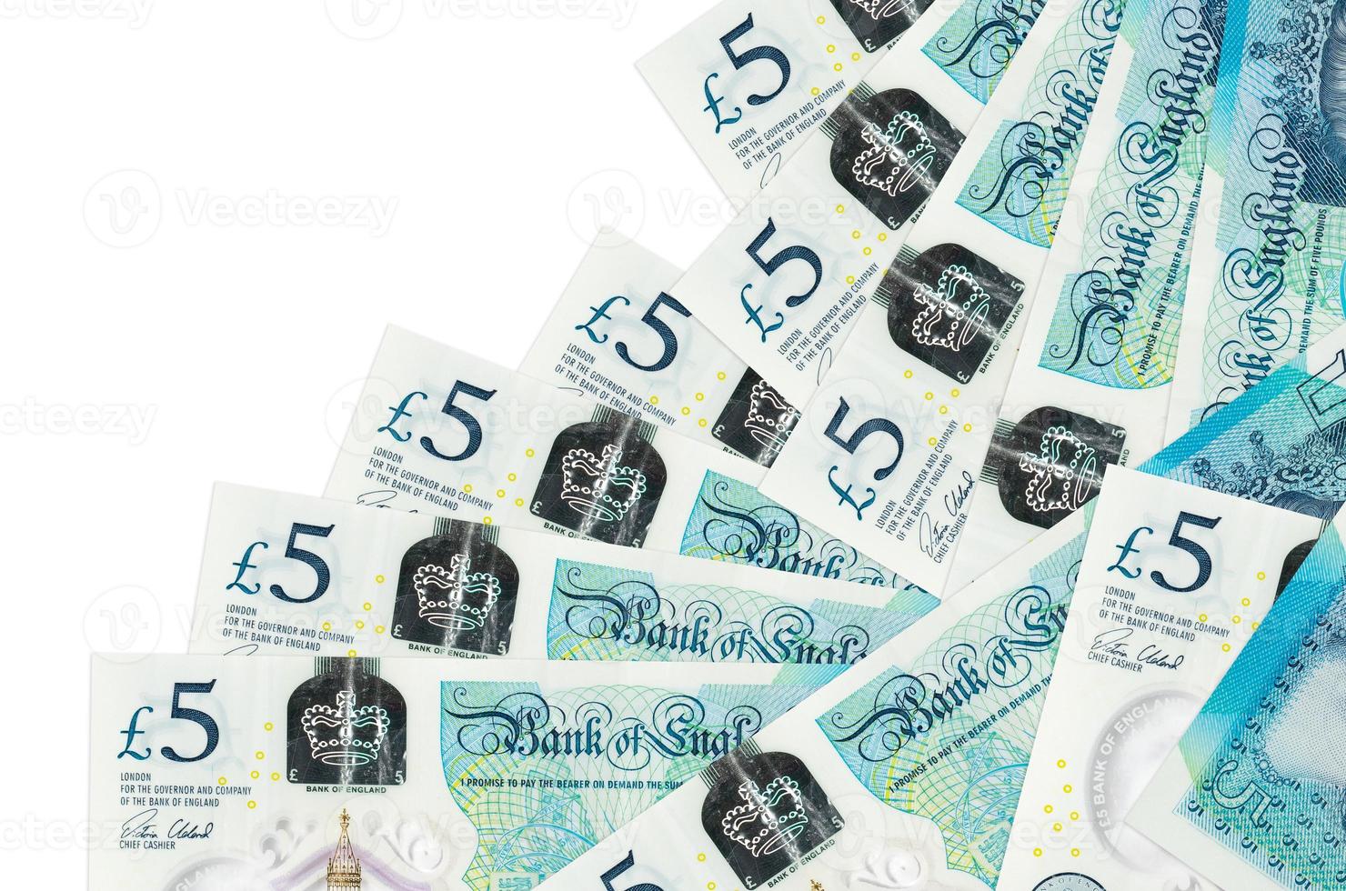 5 British pounds bills lies in different order isolated on white. Local banking or money making concept photo