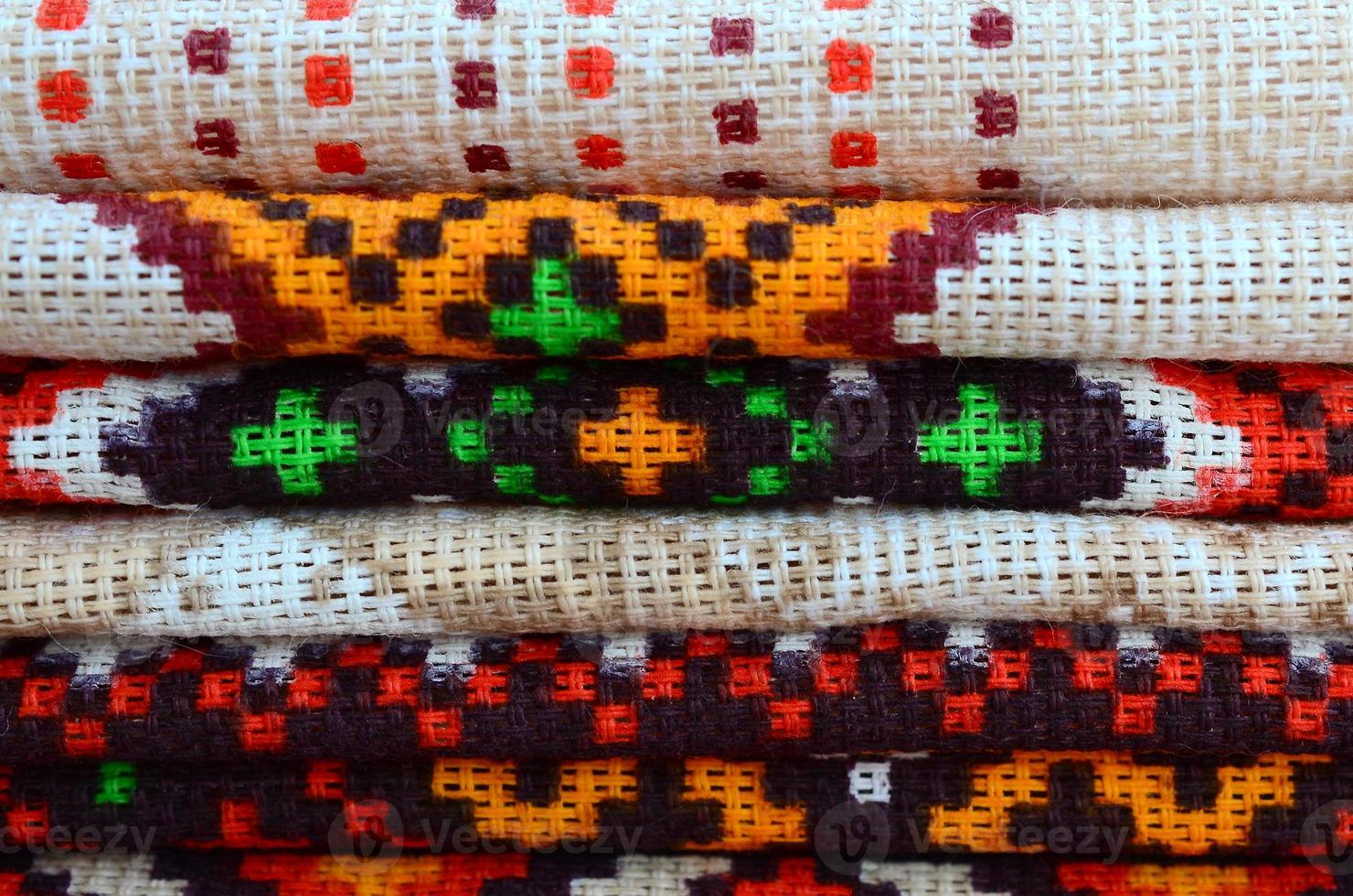 Stack of traditional Ukrainian folk art knitted embroidery patterns on textile fabric photo