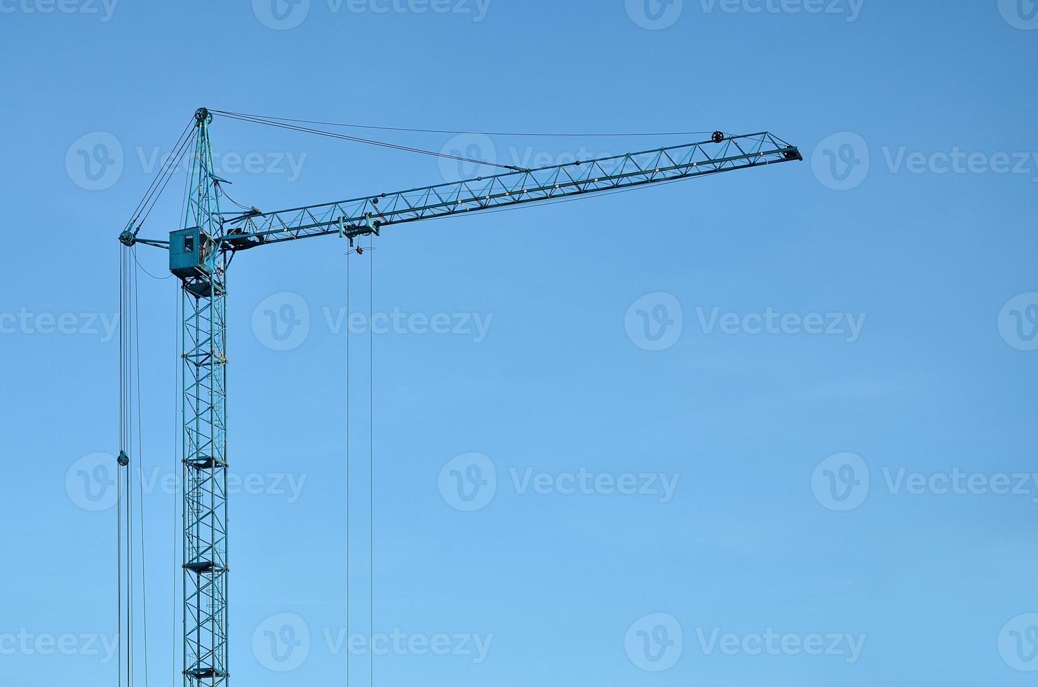 Tower crane against a blue sky photo