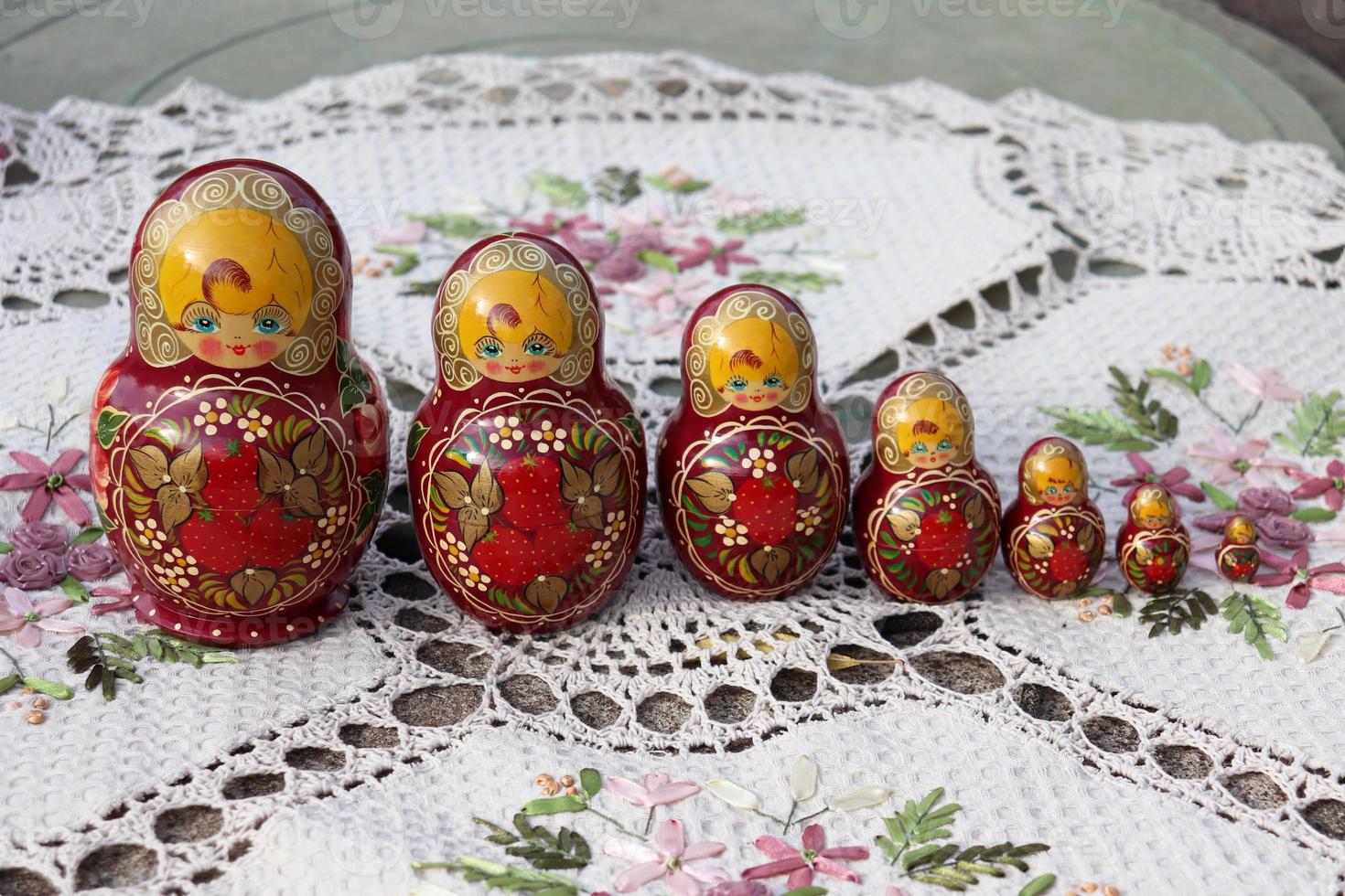 wooden nesting dolls on an embroidered napkin photo