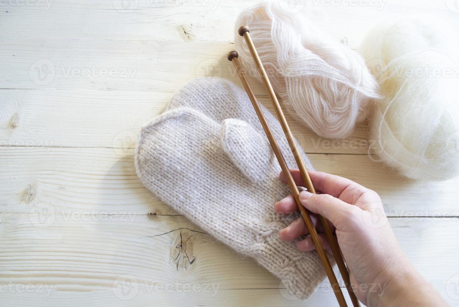Close-up of an elderly woman's hand holding knitting needles. photo