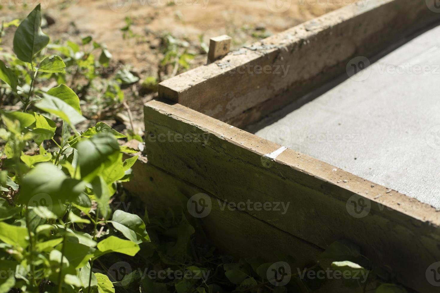 Construction work. Formwork with cement. Pouring foundation. photo