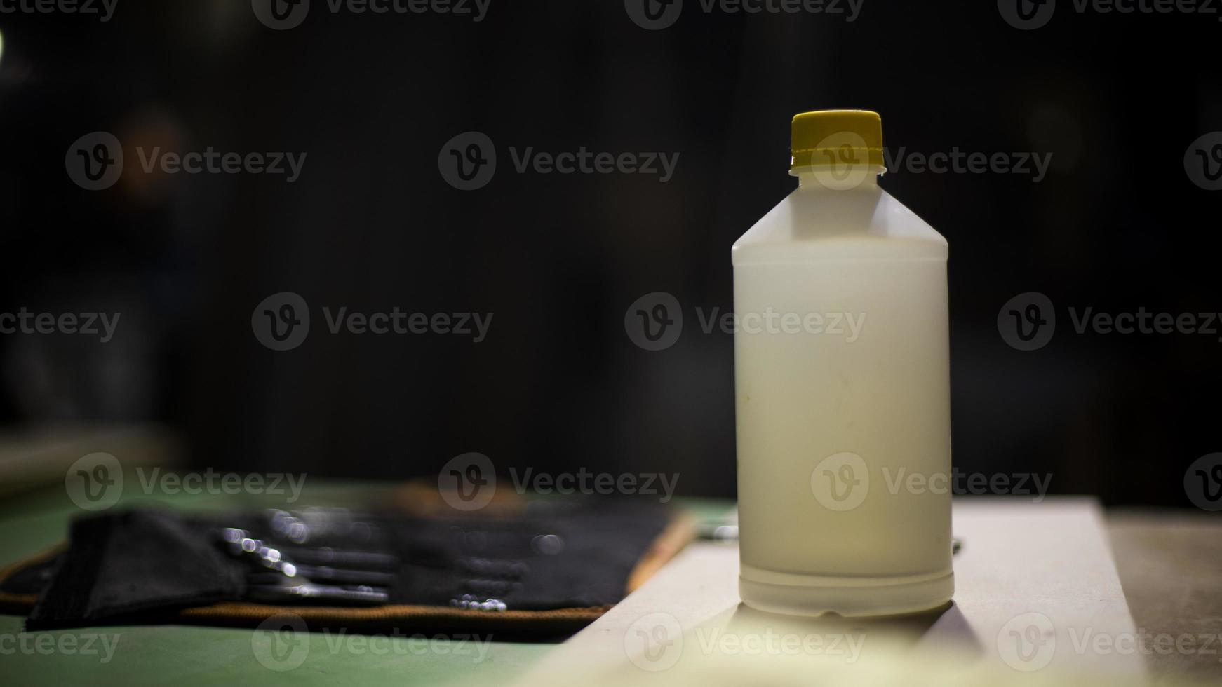 Glue on table. Container with glue. Object on table. White canister. photo