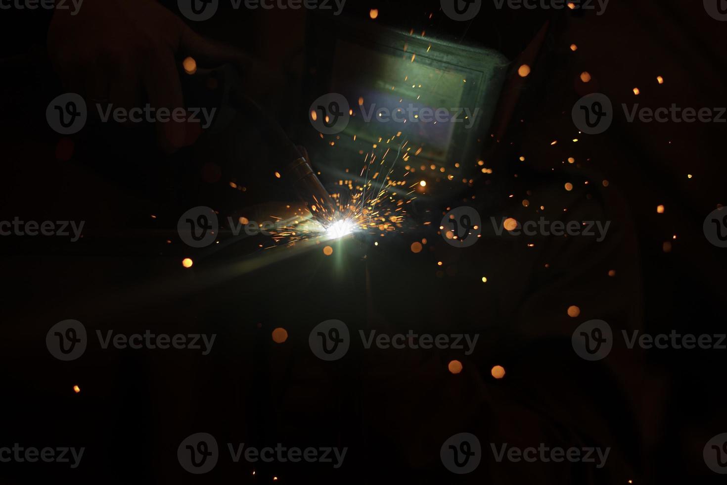 Welding work. Sparks from welding metal. Production details. photo