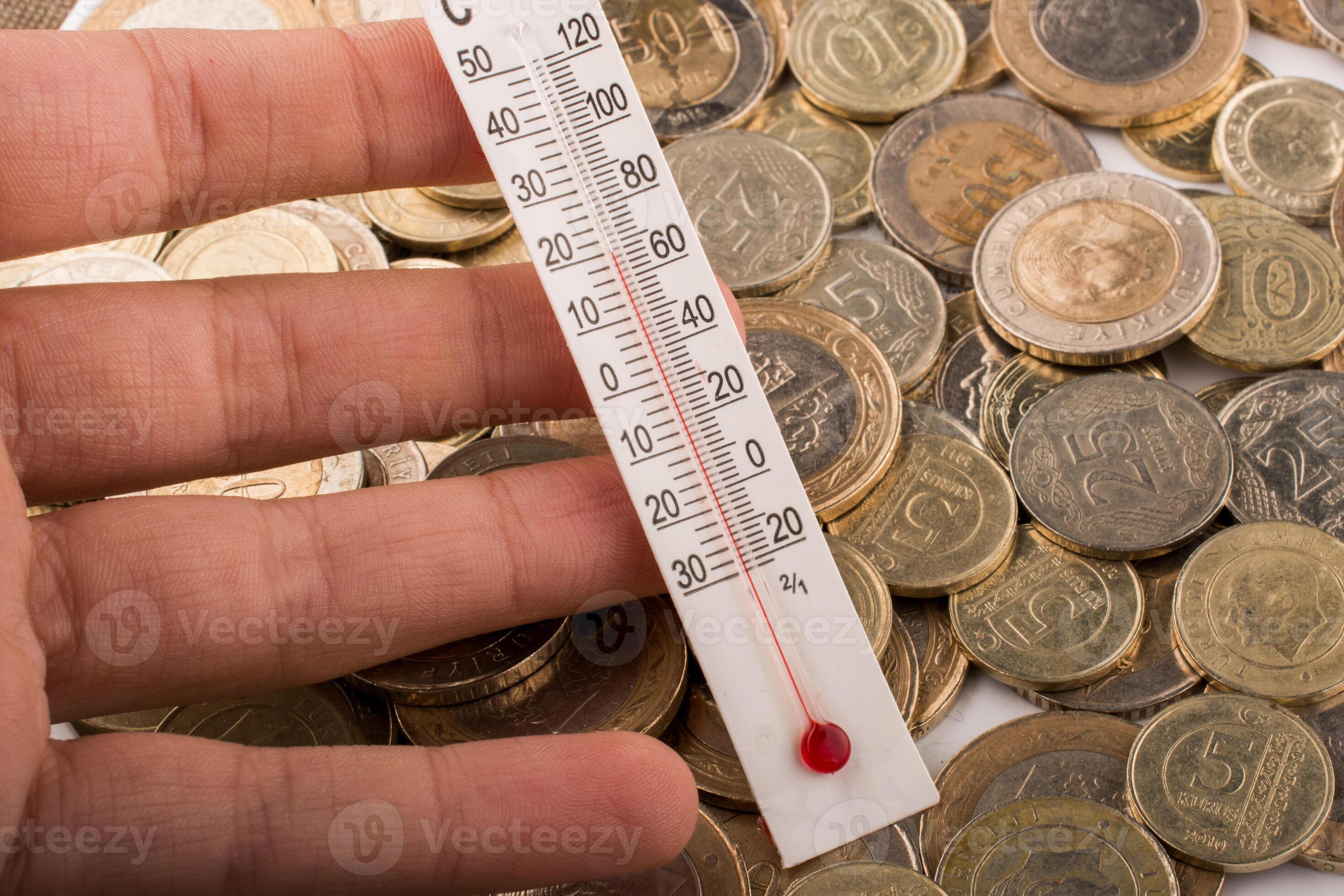 Thermometer in hand beside Turkish Lira coins 14510513 Stock Photo at