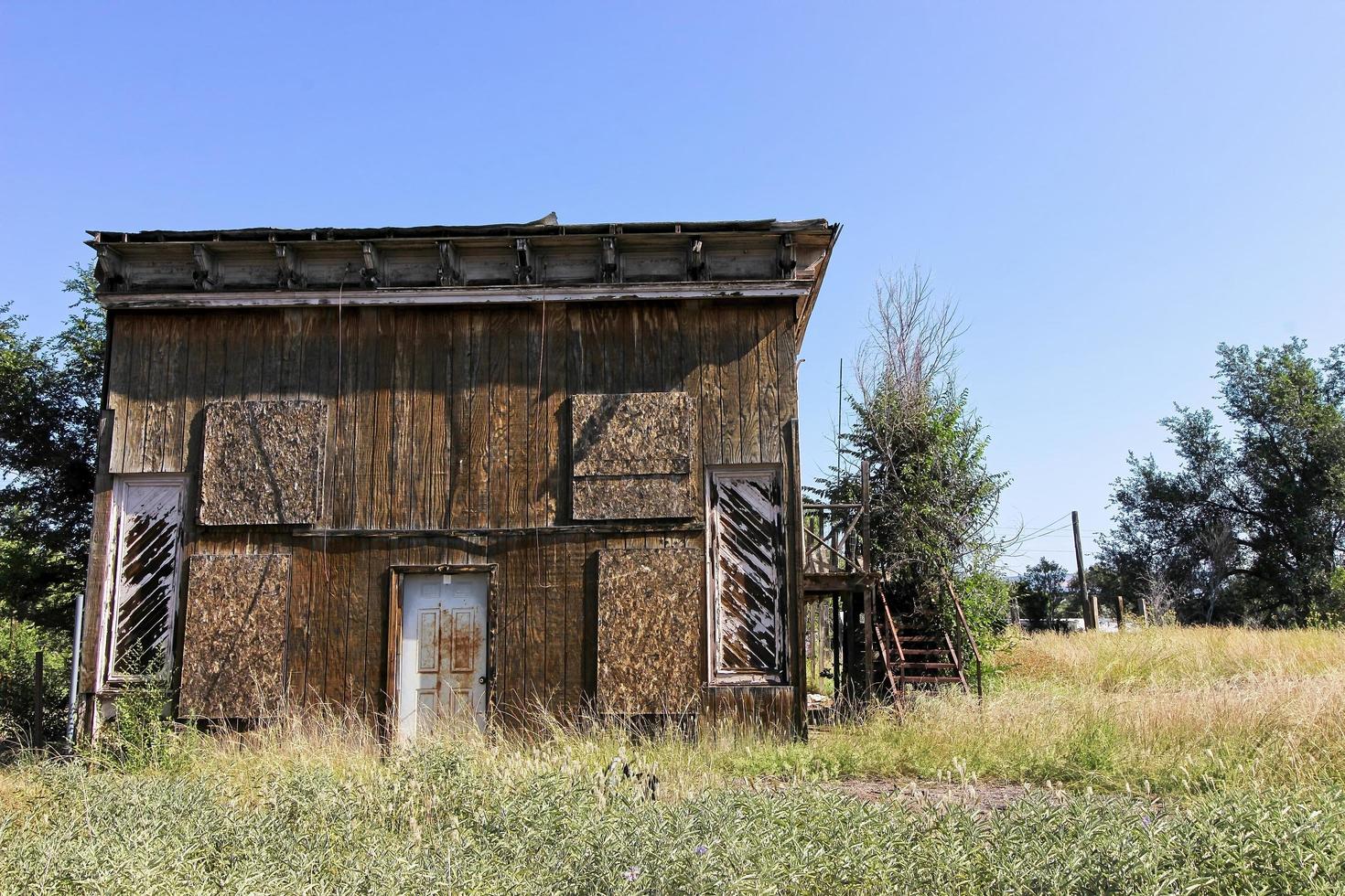 Abandoned Wooden Building With Boarded Up Windows photo