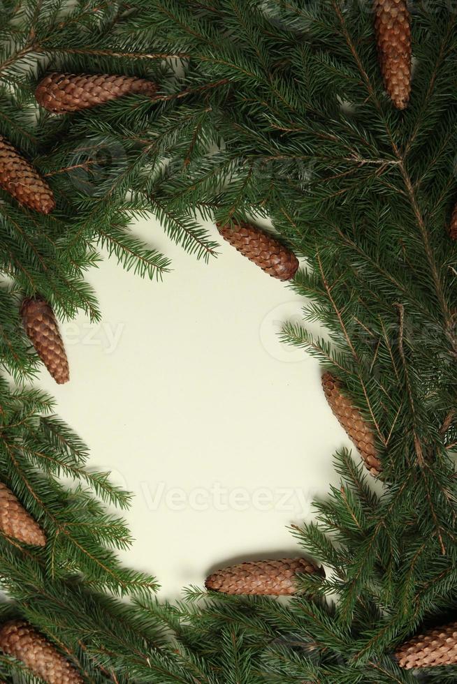 New Year's Eve background with fir branch and cones. Christmas and New Year holidays composition of pine tree branches. Happy New Year 2023 photo