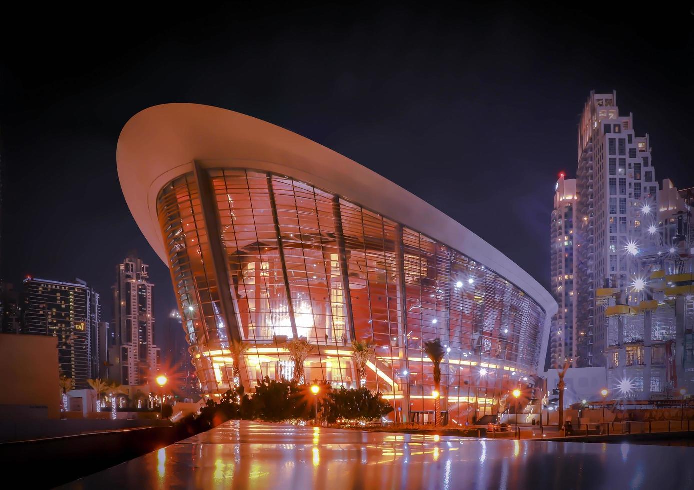 UAE December 25 2018 Dubai opera, night skyline. Holiday uae. City top view. Architecture building. Blue sky. photo