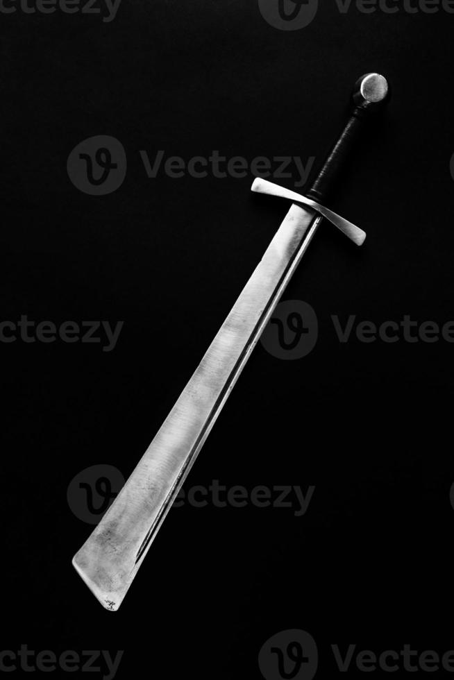 Falchion on a dark background. photo