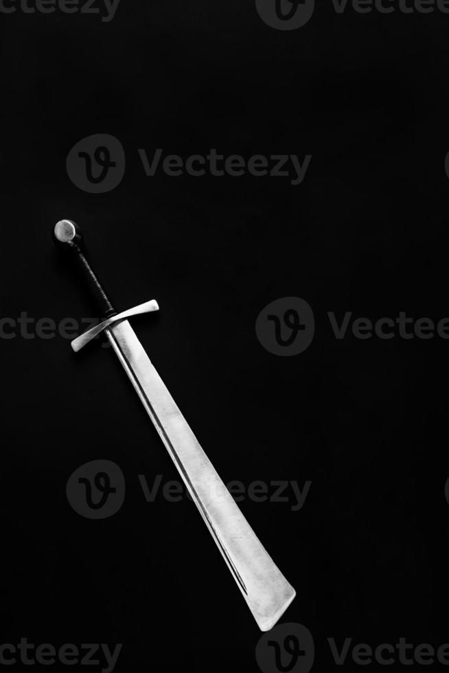 Medieval falchion on a dark background. Place for text. photo