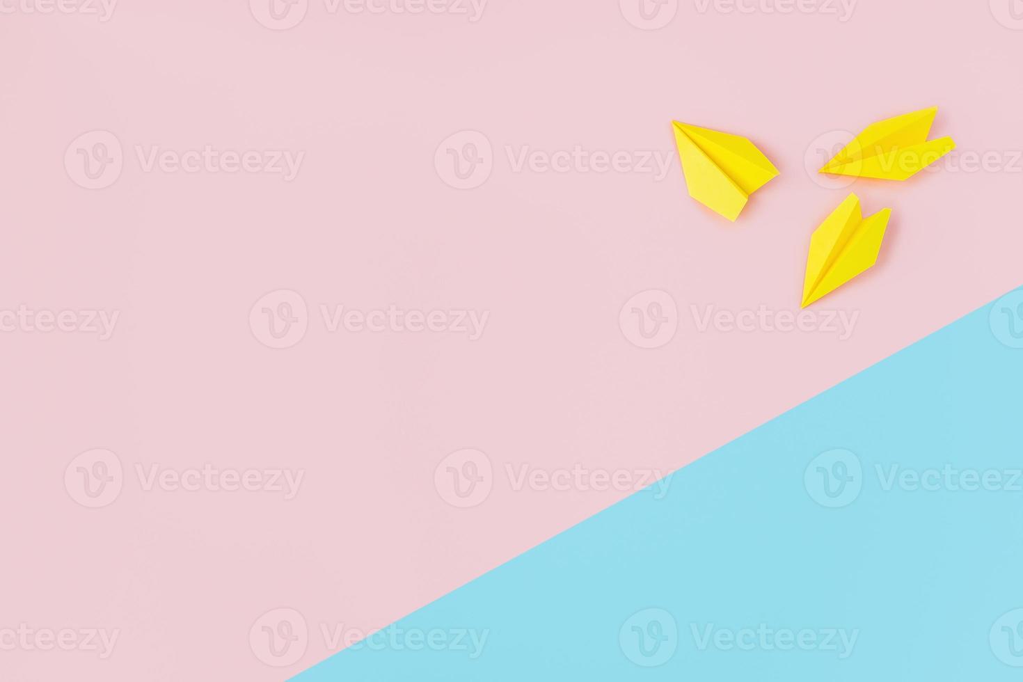 Yellow paper airplanes on a pink and blue background. photo