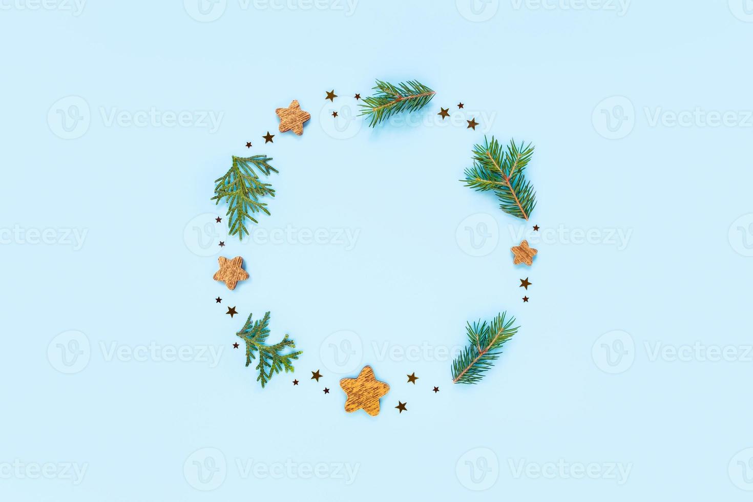 Christmas card with wooden ornaments and twigs of thuja. photo