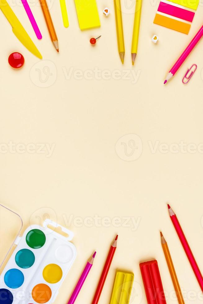 School accessories on a yellow background. Pastel colored. photo