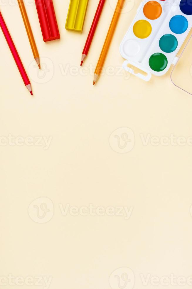 School accessories on a yellow background. Pastel colored. photo