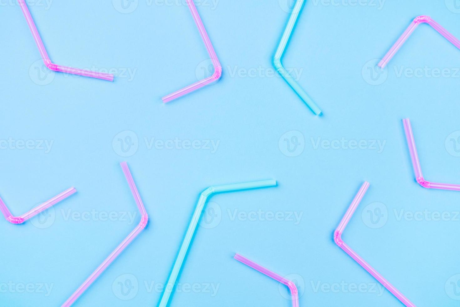 Blue and pink cocktail straws on a color background. photo