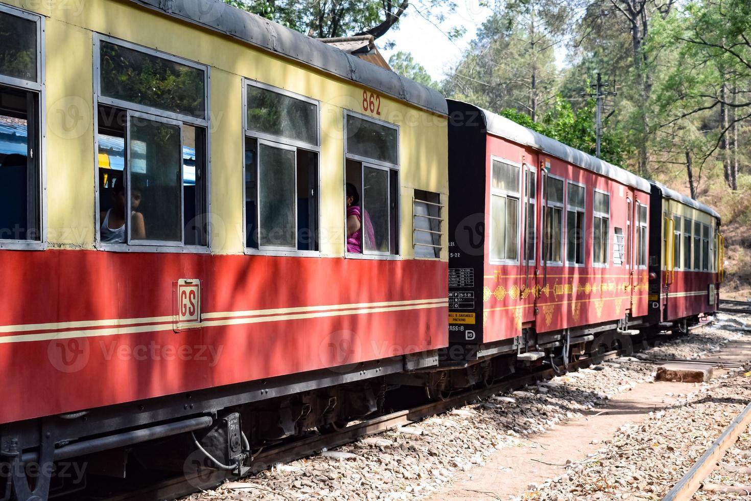 Toy Train moving on mountain slopes, beautiful view, one side mountain, one side valley moving on railway to the hill, among green natural forest. Toy train from Kalka to Shimla in India, Indian Train photo