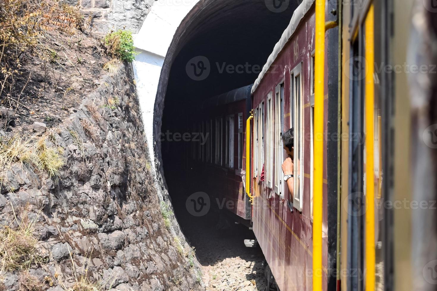 Toy Train moving on mountain slopes, beautiful view, one side mountain, one side valley moving on railway to the hill, among green natural forest. Toy train from Kalka to Shimla in India, Indian Train photo