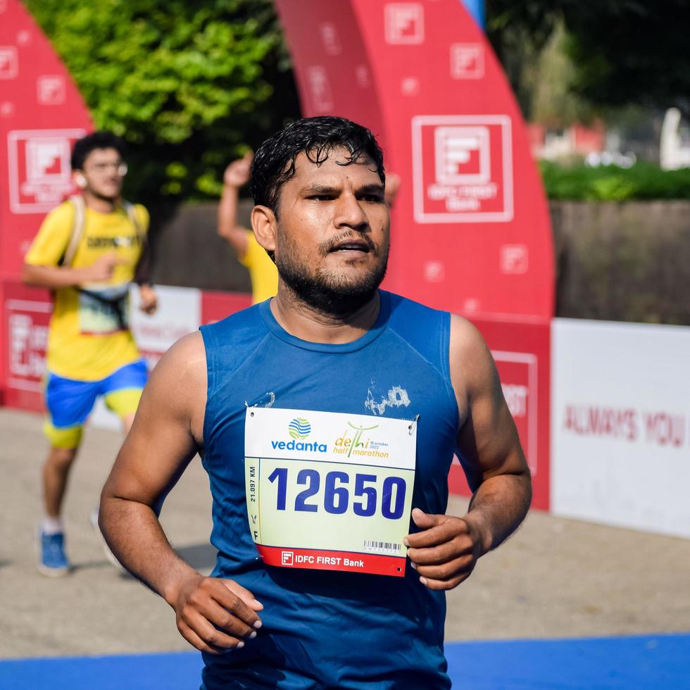 New Delhi, India - October 16 2022 - Vedanta Delhi Half Marathon race after covid in which marathon participants about to cross the finish line, Delhi Half Marathon 2022 photo