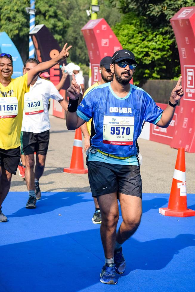 New Delhi, India - October 16 2022 - Vedanta Delhi Half Marathon race after covid in which marathon participants about to cross the finish line, Delhi Half Marathon 2022 photo