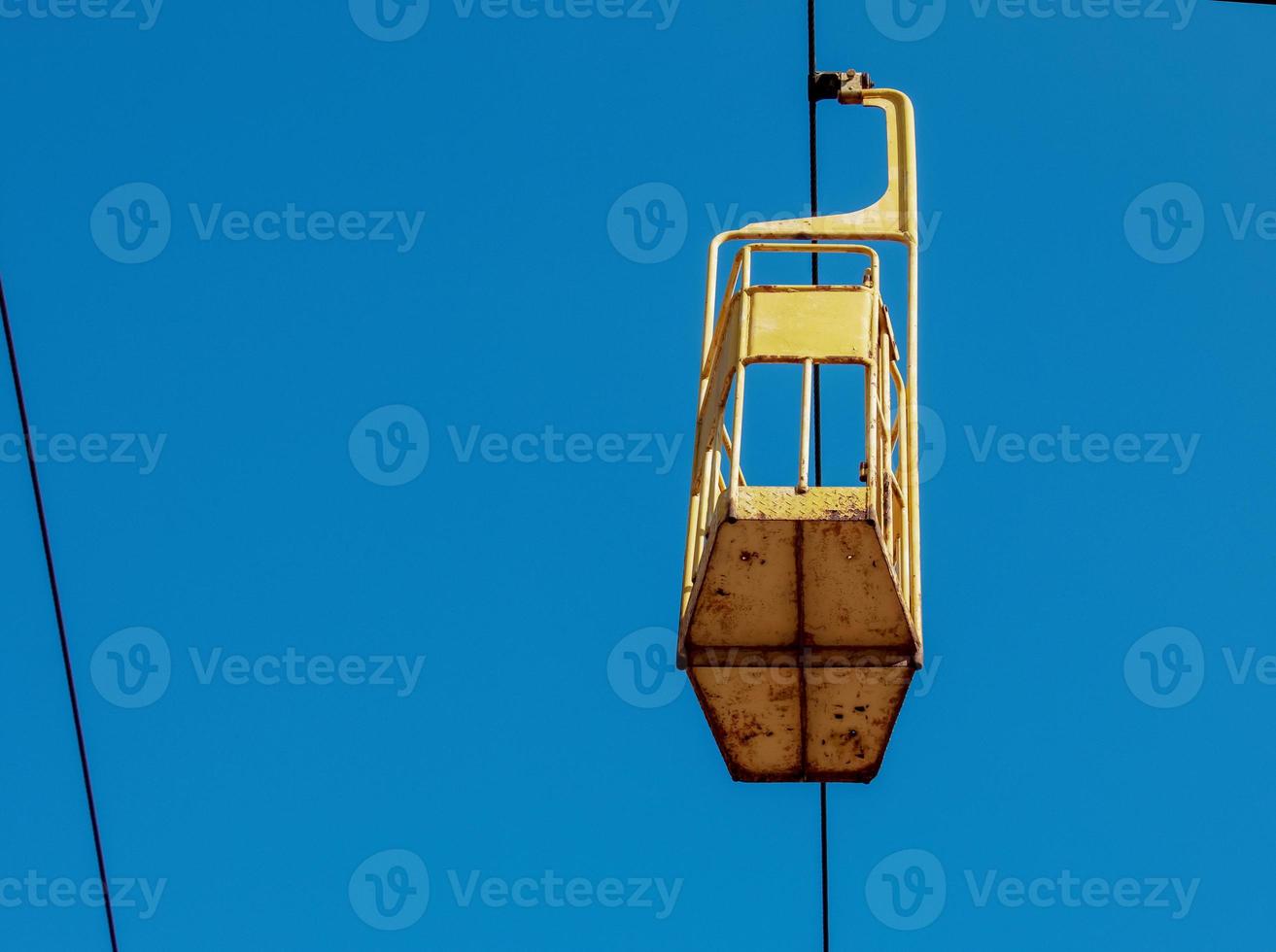 Old cable car in Dnepropetrovsk. Cable car cabins against the background of the blue sky and the urban landscape. photo