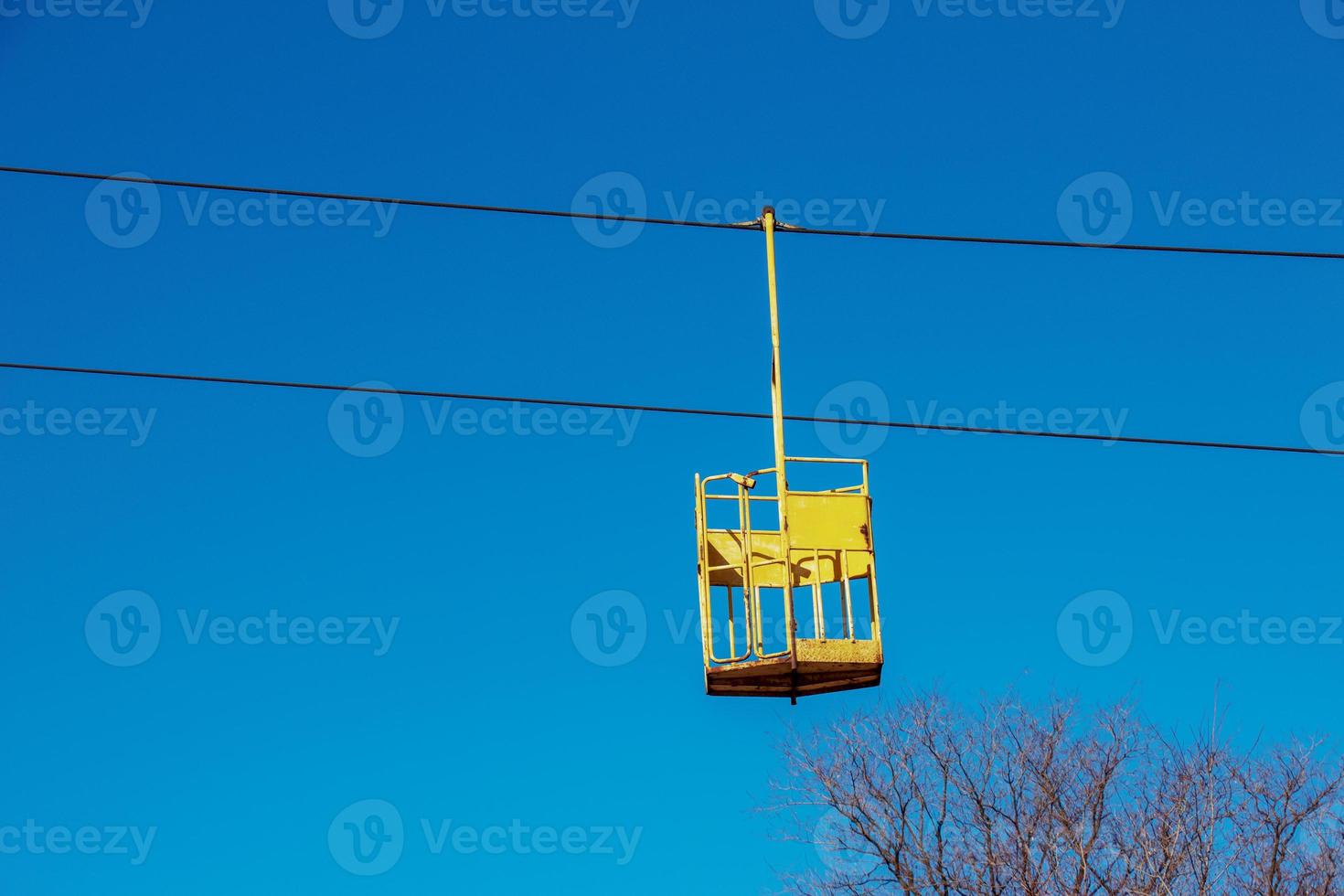 Old cable car in Dnepropetrovsk. Cable car cabins against the background of the blue sky and the urban landscape. photo