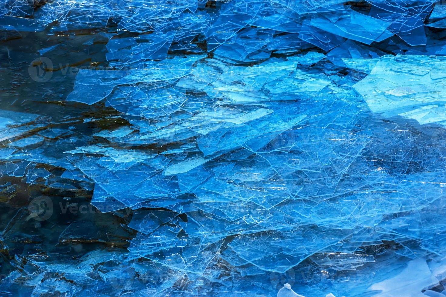 Ice surface of the river. The texture of fragments of ice and water during the icing period. Winter background. photo