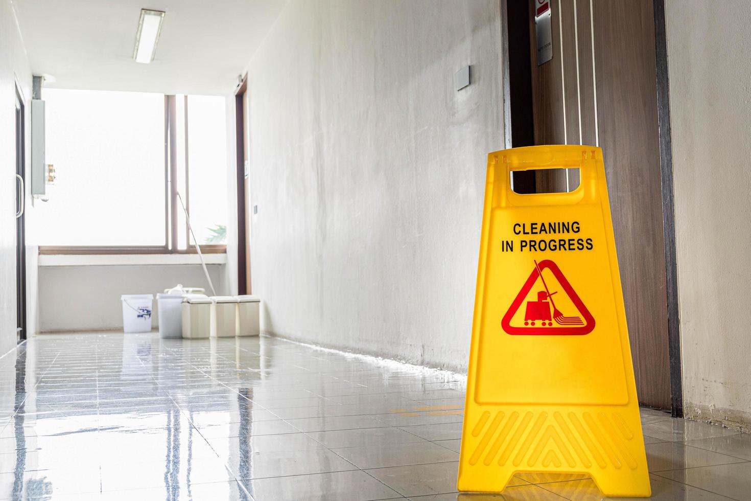 Close up yellow warning sign with message Cleaning in progress photo