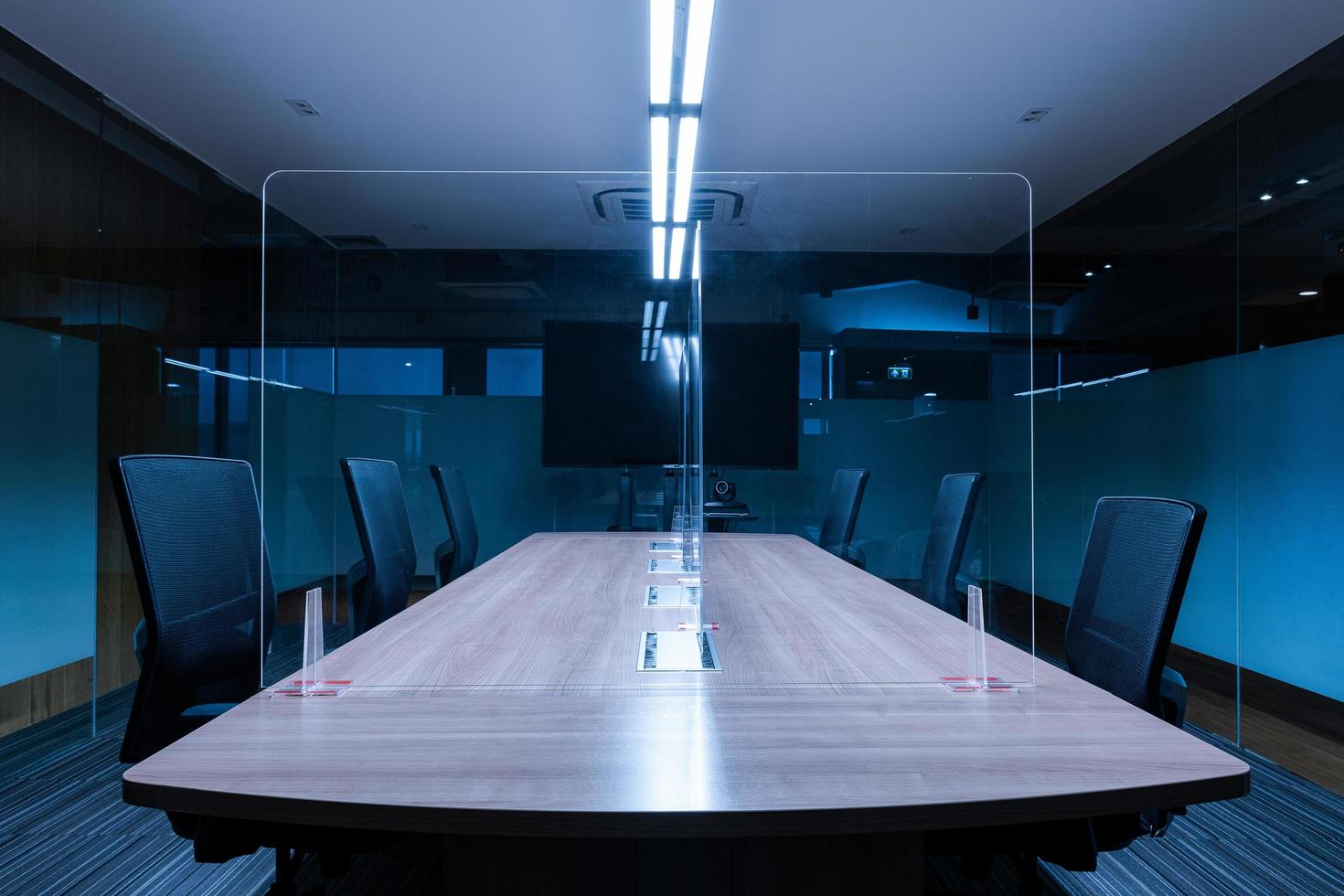 Television blank display in video conference meeting room with clear acrylic sheet separates the center on the conference table to prevent Covid-19 photo