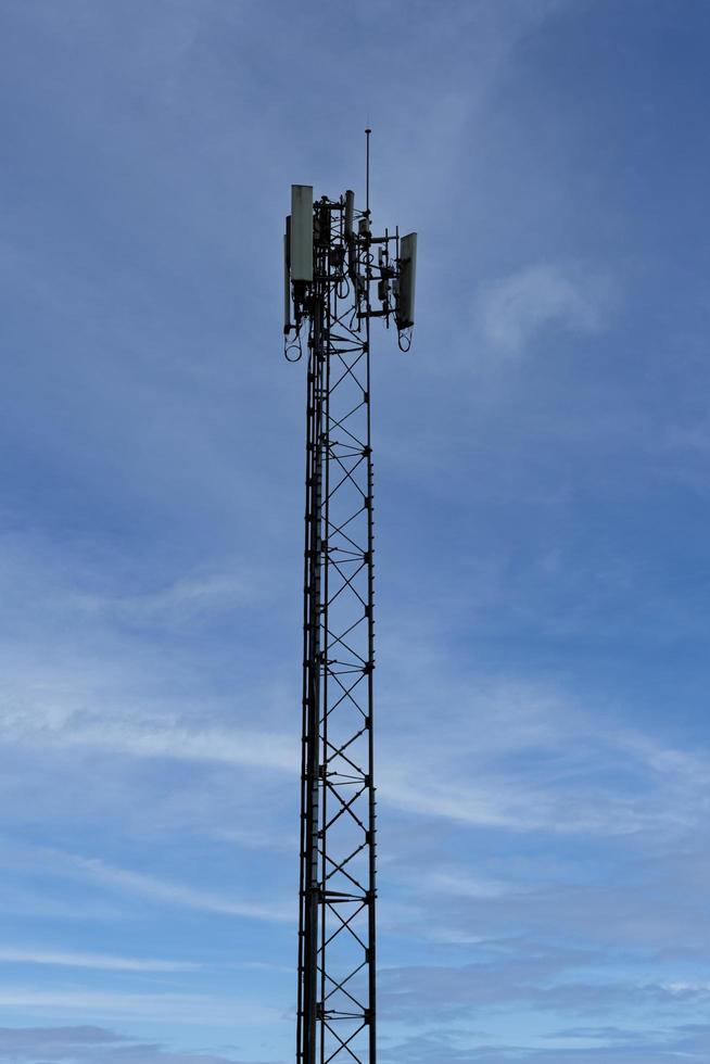 Telecommunication tower on blue sky background photo