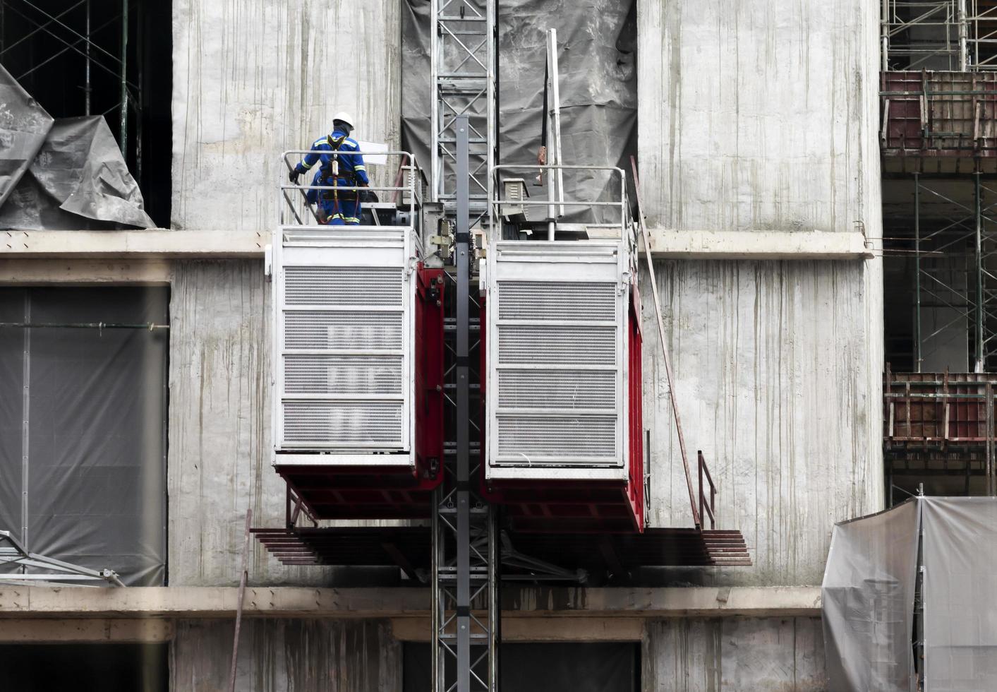 Engineers repairing elevators at construction site photo
