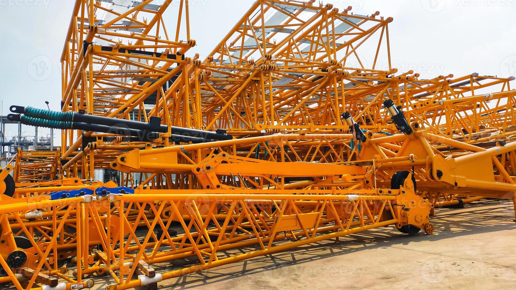 A stack of crane boom, lower section, middle section, upper section, and crane fly jib. photo
