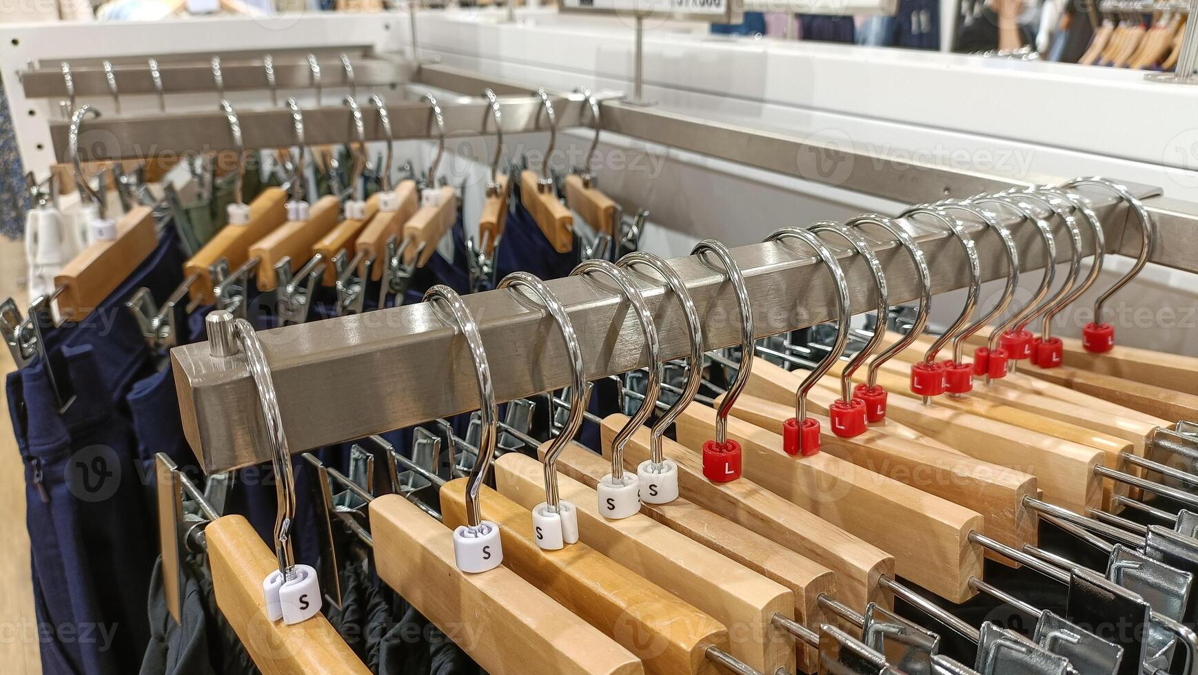 top view of hanging clothes arranged on a display rack. photo