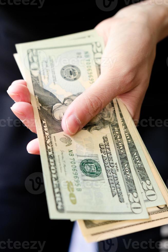 A pack of dollars in hands close-up. To count money. twenty dollar bills. Pay day. Cash payment. Transfers in dollars. photo